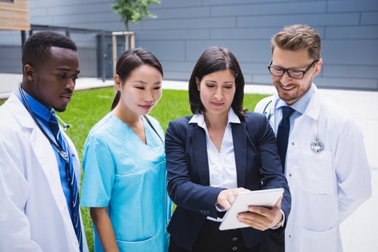 team-doctors-discussing-digital-tablet